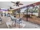 Outdoor patio, fully screened, with ceiling fans, ample seating and a spacious outdoor living area at 9611 107Th N Ave, Largo, FL 33773
