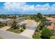 Beautiful home with water views, lush landscaping, a barrel tile roof, and brick driveway at 987 Chickadee Dr, Venice, FL 34285