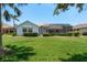An inviting backyard with a screened lanai and lush green lawn, perfect for outdoor enjoyment at 987 Chickadee Dr, Venice, FL 34285