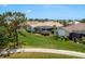 Beautiful backyard with a screened lanai, green lawn, and views of the surrounding neighborhood at 987 Chickadee Dr, Venice, FL 34285