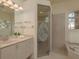 Luxurious bathroom featuring glass shower, marble vanity, and soaking tub at 987 Chickadee Dr, Venice, FL 34285