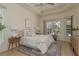 Bright bedroom with tray ceilings and view of the pool at 987 Chickadee Dr, Venice, FL 34285