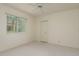 Bright bedroom with a ceiling fan, neutral carpet, and a large window overlooking greenery at 987 Chickadee Dr, Venice, FL 34285