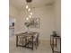 Dining room with modern lighting fixture and views of the kitchen area at 987 Chickadee Dr, Venice, FL 34285
