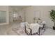 Bright foyer featuring tile flooring, glass block window, and stylish decor at 987 Chickadee Dr, Venice, FL 34285
