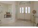 Inviting foyer with tile flooring, glass block window, and views into the adjacent office at 987 Chickadee Dr, Venice, FL 34285