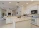 Open kitchen featuring a center island, white cabinets, and modern appliances at 987 Chickadee Dr, Venice, FL 34285