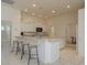 Spacious kitchen featuring white cabinetry, an island with bar stool seating, and ample counter space at 987 Chickadee Dr, Venice, FL 34285