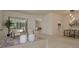 Cozy living room with decorative rug, modern furniture, and access to outdoor living space at 987 Chickadee Dr, Venice, FL 34285