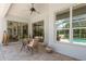 Inviting patio area with tile flooring, wicker seating, and a view of the sparkling pool at 987 Chickadee Dr, Venice, FL 34285