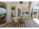 Charming patio with brick floors, comfortable wicker furniture, and views of the surrounding property at 987 Chickadee Dr, Venice, FL 34285