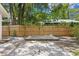 Secluded backyard with a wooden deck, paver circle, and privacy fence at 1003 E Emma St, Tampa, FL 33603