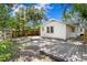 Lush backyard with mature trees, a paver patio, and a wooden deck at 1003 E Emma St, Tampa, FL 33603