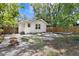 Spacious backyard featuring a concrete paver patio, wooden deck, and secure fencing at 1003 E Emma St, Tampa, FL 33603