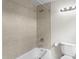 Tiled bathroom with a bathtub, shower, and a modern toilet at 1003 E Emma St, Tampa, FL 33603