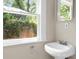 Clean bathroom with a pedestal sink, bright lighting, and a large window at 1003 E Emma St, Tampa, FL 33603