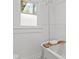 Bright bathroom featuring a clawfoot tub with a wooden tray and classic wainscoting at 1003 E Emma St, Tampa, FL 33603