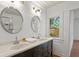 Bathroom featuring double sinks and updated lighting fixtures at 1003 E Emma St, Tampa, FL 33603