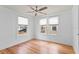 Bedroom featuring hardwood floors, a ceiling fan, and ample natural light through two windows at 1003 E Emma St, Tampa, FL 33603