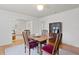 Dining room with hardwood floors, neutral walls, fireplace and seamless flow to living room at 1003 E Emma St, Tampa, FL 33603