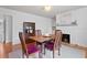 Elegant dining room with hardwood floors, neutral walls, fireplace and seamless flow to kitchen at 1003 E Emma St, Tampa, FL 33603