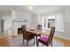 Charming dining room featuring a cozy fireplace, hardwood floors, and plenty of natural light at 1003 E Emma St, Tampa, FL 33603