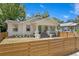 Beautifully renovated home showcasing a quaint porch and a stylish horizontal wood fence at 1003 E Emma St, Tampa, FL 33603