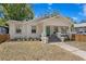 Charming single-story home with a welcoming front porch, light exterior paint, and well-kept landscaping at 1003 E Emma St, Tampa, FL 33603