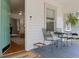 Inviting front porch with seating area, showing view to the interior of the home at 1003 E Emma St, Tampa, FL 33603