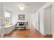Hallway with hardwood flooring, a bench, and an open doorway at 1003 E Emma St, Tampa, FL 33603