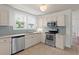 Updated kitchen with stainless steel appliances and light countertops at 1003 E Emma St, Tampa, FL 33603
