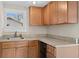 Charming kitchen boasting wooden cabinets, granite countertops, and stainless-steel appliances at 1003 E Emma St, Tampa, FL 33603