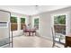 Sunlit living room with tile floors, white trim, and large windows offering backyard views at 1003 E Emma St, Tampa, FL 33603