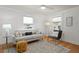 Bright living room featuring hardwood floors, neutral decor, and a large window for natural light at 1003 E Emma St, Tampa, FL 33603
