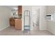 Neutral space with tile floors, an AC unit, and entryways to the kitchen and bathroom at 1003 E Emma St, Tampa, FL 33603