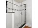Modern glass shower features black and white tiling at 1003 E Emma St, Tampa, FL 33603