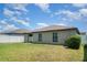 Green backyard view with a privacy fence and part of house including two windows at 10104 Carloway Hills Dr, Wimauma, FL 33598