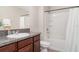 Bathroom with granite counters, wood cabinets, and shower/tub combo at 10104 Carloway Hills Dr, Wimauma, FL 33598