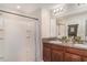 Neat bathroom with double sinks, walk in shower, granite countertops and ample mirror space at 10104 Carloway Hills Dr, Wimauma, FL 33598