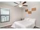 Cozy bedroom featuring a ceiling fan, neutral walls, and a comfortable bed with white linens at 10104 Carloway Hills Dr, Wimauma, FL 33598