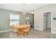 Bright dining area showcasing a wooden table, chairs, and view into the dining area at 10104 Carloway Hills Dr, Wimauma, FL 33598