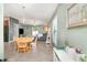 Bright dining area showcasing a wooden table, chairs, and view into the living room at 10104 Carloway Hills Dr, Wimauma, FL 33598
