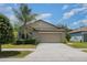 Charming one-story home featuring a well-maintained lawn and a spacious two-car garage at 10104 Carloway Hills Dr, Wimauma, FL 33598