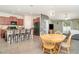 Open concept living room with a view of the kitchen and dining area with lots of natural light at 10104 Carloway Hills Dr, Wimauma, FL 33598