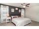 Cozy main bedroom with a ceiling fan, two windows and soft textures for a relaxing atmosphere at 10104 Carloway Hills Dr, Wimauma, FL 33598