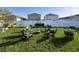 Charming backyard with seating, green grass and white vinyl privacy fence at 10123 Carp Hollow Rd, Sun City Center, FL 33573