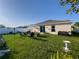 Picturesque backyard featuring a well-manicured lawn, garden decor, and a peaceful outdoor setting at 10123 Carp Hollow Rd, Sun City Center, FL 33573