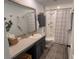 This bathroom features a shower with tile surround, modern fixtures, and storage space at 10123 Carp Hollow Rd, Sun City Center, FL 33573