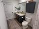 Well-lit bathroom with stylish vanity, dark cabinets, and a decorative patterned rug at 10123 Carp Hollow Rd, Sun City Center, FL 33573