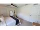Bright bedroom featuring neutral walls, a modern ceiling fan, and minimalist decor at 10123 Carp Hollow Rd, Sun City Center, FL 33573